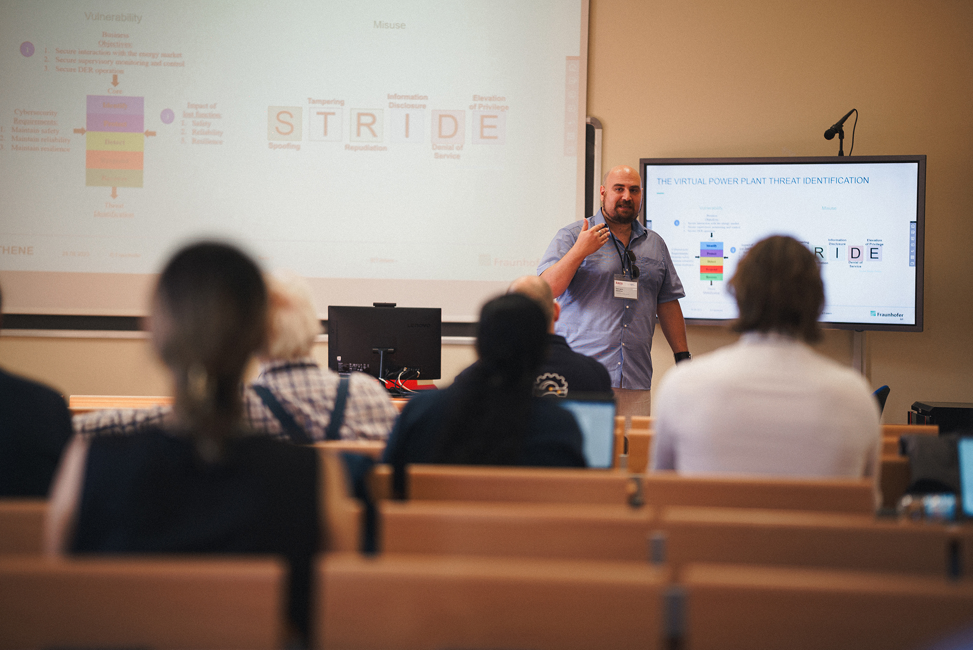 A man presenting to a group of people, engaging them with his speech and visual aids.