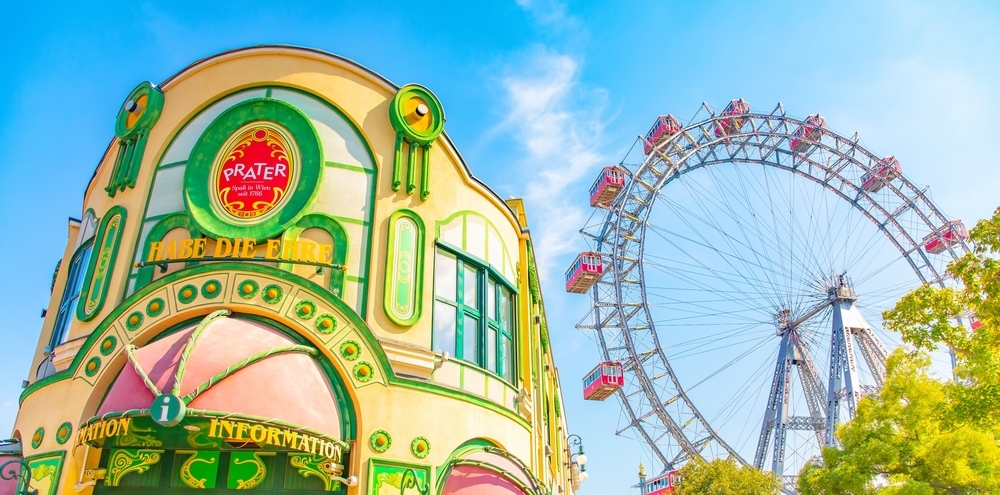 Colorful entrance building of Vienna´s Prater. In the back the giant ferris wheel.